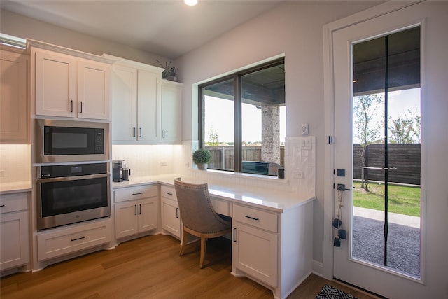 2708 Darlington Rd, Northlake, TX 76226 - home office with built in desk, plenty of natural light, light wood-style floors, and recessed lighting