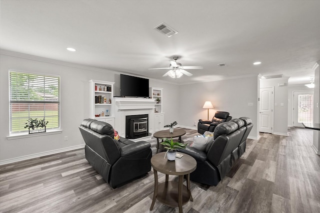 200 Oakview Cir, Mexia, TX 76667 - living room featuring wood finished floors, a ceiling fan, ornamental molding, a glass covered fireplace, and baseboards