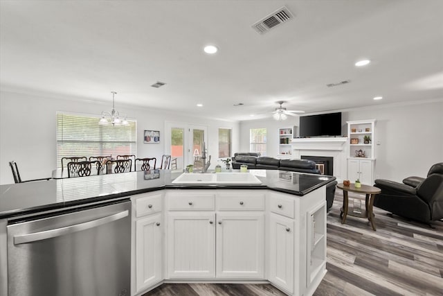 200 Oakview Cir, Mexia, TX 76667 - kitchen featuring dishwasher, dark countertops, open floor plan, a sink, and a fireplace
