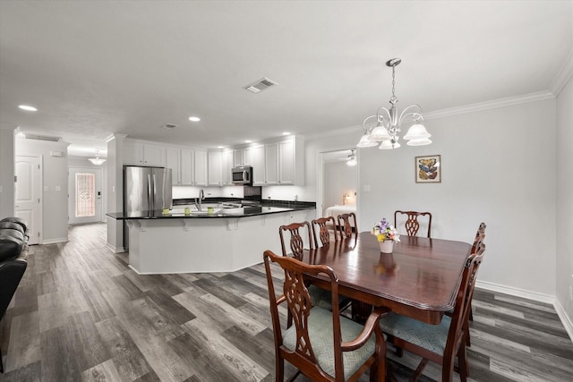 200 Oakview Cir, Mexia, TX 76667 - dining area featuring ornamental molding, dark wood-type flooring, baseboards, recessed lighting, and a chandelier