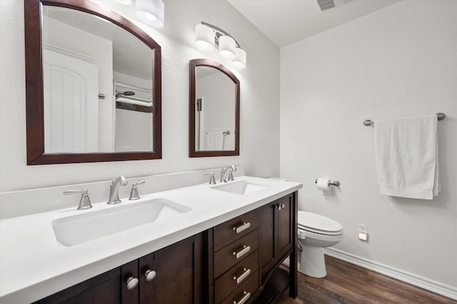 200 Oakview Cir, Mexia, TX 76667 - full bath with wood finished floors, baseboards, double vanity, and toilet
