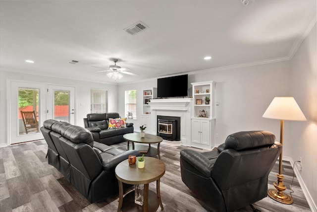 200 Oakview Cir, Mexia, TX 76667 - living area featuring crown molding, ceiling fan, wood finished floors, a glass covered fireplace, and baseboards