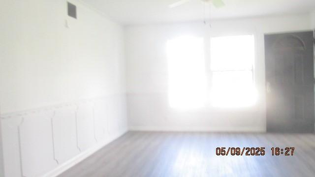 empty room featuring light wood-type flooring and a ceiling fan