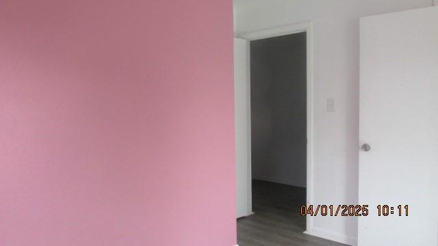 empty room with dark wood-style flooring