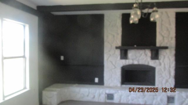 bathroom with healthy amount of natural light and a chandelier
