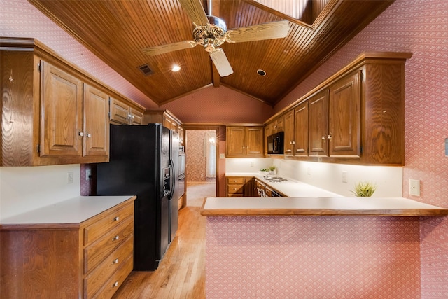 11103 Manorview Cir, Dallas, TX 75228 - kitchen with black appliances, light wood finished floors, wallpapered walls, vaulted ceiling, and light countertops