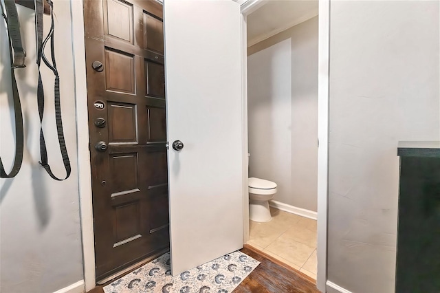 4800 Northway Dr Unit 17A, Dallas, TX 75206 - bathroom with toilet, baseboards, and wood finished floors