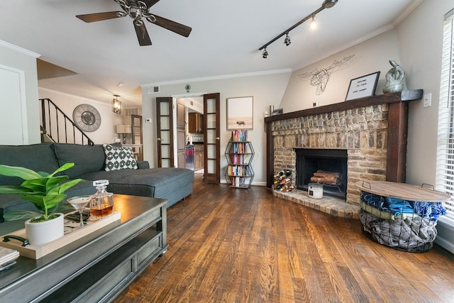 4800 Northway Dr Unit 17A, Dallas, TX 75206 - living room featuring ceiling fan, crown molding, wood finished floors, a brick fireplace, and stairway