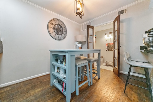 4800 Northway Dr Unit 17A, Dallas, TX 75206 - dining room featuring wood finished floors, baseboards, and crown molding