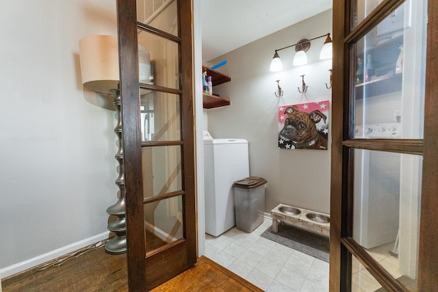 4800 Northway Dr Unit 17A, Dallas, TX 75206 - washroom featuring washer / clothes dryer, wood finished floors, and baseboards