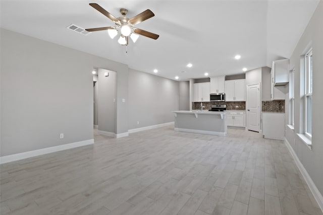 612 Amenduni Ln, Anna, TX 75409 - unfurnished living room featuring ceiling fan, recessed lighting, baseboards, and light wood-type flooring