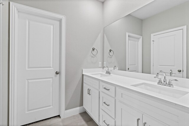 612 Amenduni Ln, Anna, TX 75409 - full bathroom with double vanity and baseboards