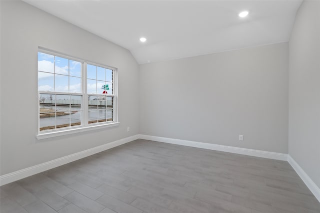 612 Amenduni Ln, Anna, TX 75409 - unfurnished room featuring baseboards, lofted ceiling, wood finished floors, and recessed lighting