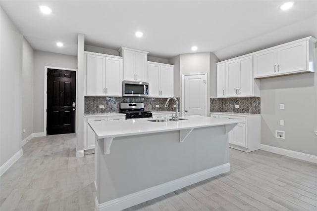 612 Amenduni Ln, Anna, TX 75409 - kitchen with stainless steel appliances, a sink, backsplash, white cabinets, and recessed lighting