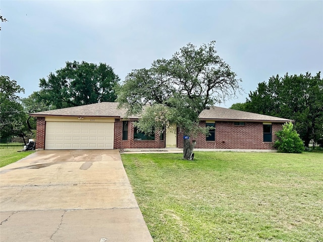 677 County Road 3081, Lampasas, TX 76550 - ranch-style house with an attached garage, concrete driveway, and a front lawn