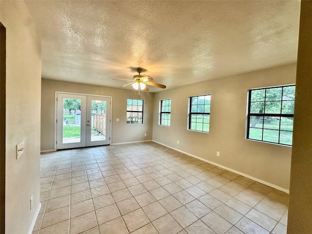 677 County Road 3081, Lampasas, TX 76550 - empty room with a ceiling fan, a textured ceiling, french doors, baseboards, and light tile patterned floors