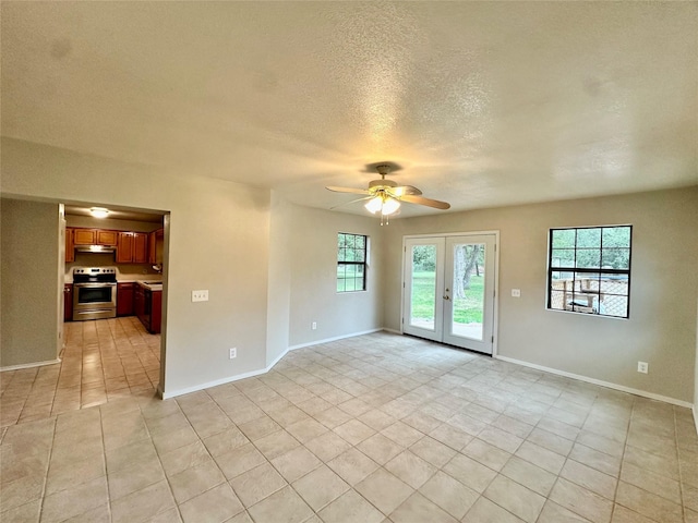 677 County Road 3081, Lampasas, TX 76550 - empty room featuring a ceiling fan, light tile patterned floors, french doors, a textured ceiling, and baseboards