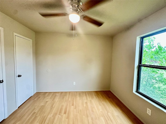 677 County Road 3081, Lampasas, TX 76550 - unfurnished room featuring light wood-type flooring, ceiling fan, baseboards, and a textured ceiling