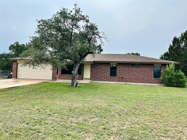 677 County Road 3081, Lampasas, TX 76550 - view of front of home featuring driveway, an attached garage, a front yard, and brick siding