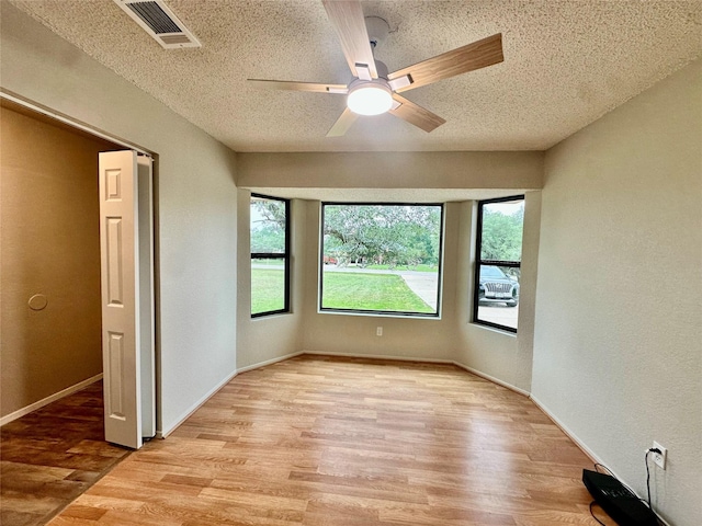 677 County Road 3081, Lampasas, TX 76550 - unfurnished room featuring light wood-style flooring, a ceiling fan, a textured ceiling, and baseboards