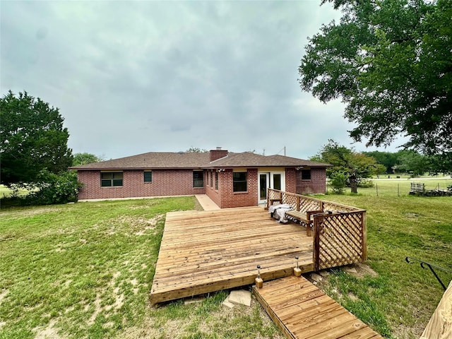 677 County Road 3081, Lampasas, TX 76550 - rear view of house featuring brick siding, a chimney, and a deck