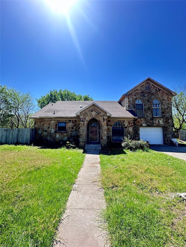 833 W Live Oak St, Jacksboro, TX 76458 - view of front of property featuring stone siding, asphalt driveway, and a garage