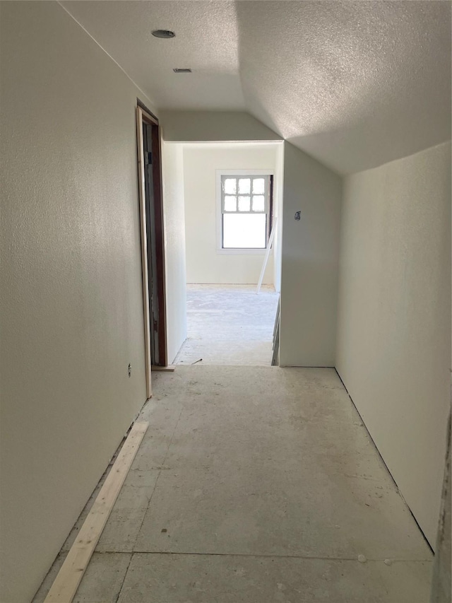 833 W Live Oak St, Jacksboro, TX 76458 - hallway featuring a textured ceiling and vaulted ceiling