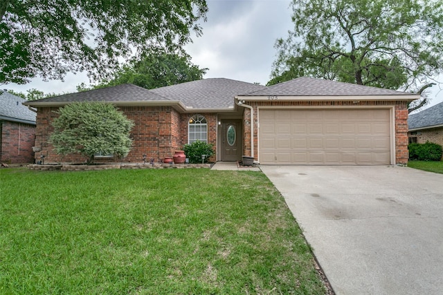 905 Wildwood Cir, Grapevine, TX 76051 - ranch-style home featuring concrete driveway, an attached garage, a front lawn, brick siding, and a shingled roof