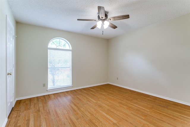 905 Wildwood Cir, Grapevine, TX 76051 - unfurnished room with light wood-style flooring, ceiling fan, baseboards, and a textured ceiling