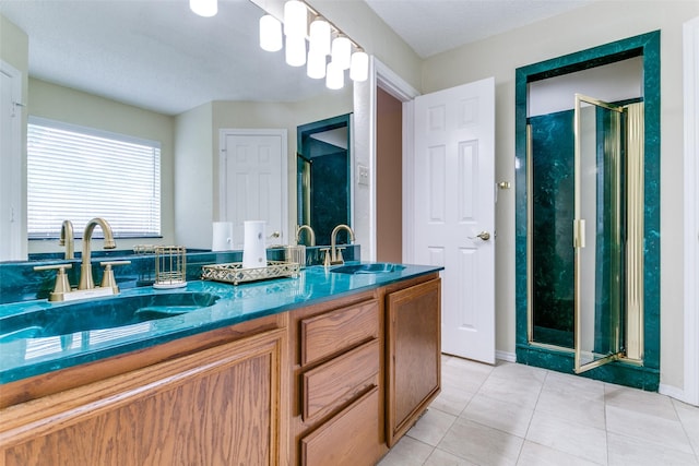905 Wildwood Cir, Grapevine, TX 76051 - bathroom with a shower stall, double vanity, tile patterned flooring, and baseboards