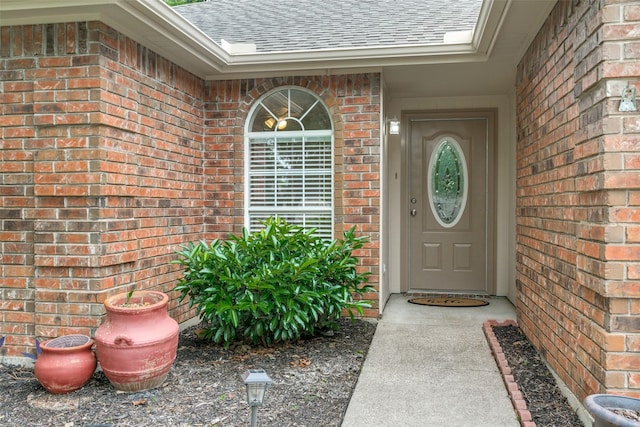 905 Wildwood Cir, Grapevine, TX 76051 - doorway to property featuring a shingled roof and brick siding