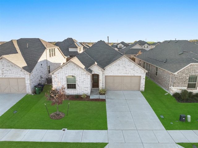 5836 Priory Dr, Celina, TX 76227 - french country style house featuring driveway, a front lawn, a garage, and roof with shingles