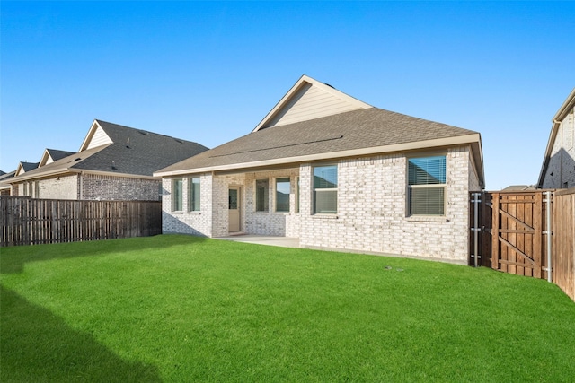 5836 Priory Dr, Celina, TX 76227 - back of house with a gate, brick siding, roof with shingles, and a patio area