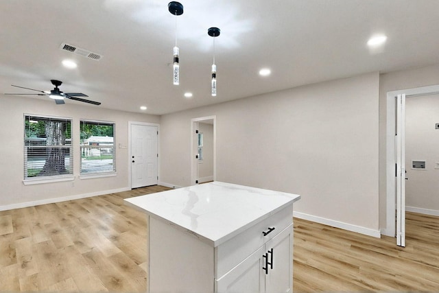 3103 Andrea Ln, Dallas, TX 75228 - kitchen featuring light wood-type flooring, pendant lighting, recessed lighting, a kitchen island, and open floor plan