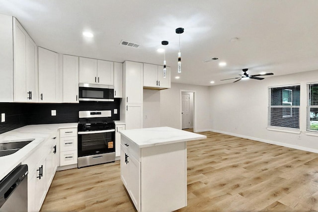 3103 Andrea Ln, Dallas, TX 75228 - kitchen featuring stainless steel appliances, recessed lighting, light wood-style floors, ceiling fan, and light stone counters