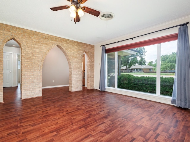 905 High Rd, Coleman, TX 76834 - unfurnished room with arched walkways, a ceiling fan, wood finished floors, brick wall, and crown molding