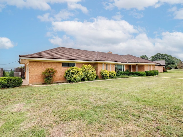 905 High Rd, Coleman, TX 76834 - ranch-style home featuring central air condition unit, brick siding, a front yard, a tile roof, and a chimney