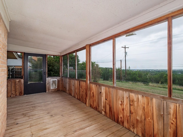 905 High Rd, Coleman, TX 76834 - unfurnished sunroom with wood-type flooring, a textured ceiling, and wood walls