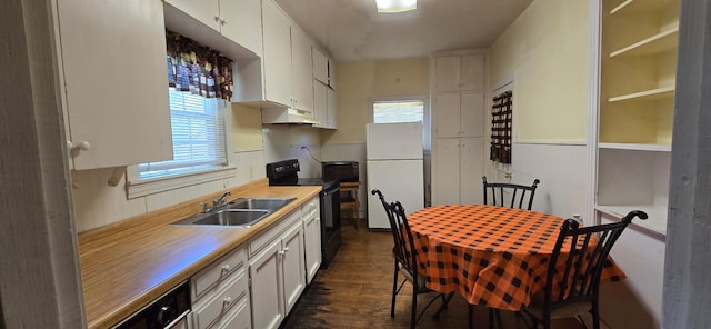 2821 Delaware Trl, Lake Worth, TX 76135 - kitchen featuring black appliances, under cabinet range hood, a sink, dark wood-style flooring, and light countertops