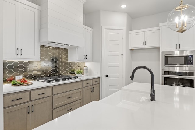 1015 Olympic Dr, Rockwall, TX 75087 - kitchen featuring stainless steel appliances, a sink, light countertops, custom range hood, and recessed lighting