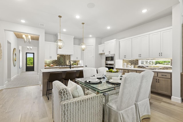 1015 Olympic Dr, Rockwall, TX 75087 - dining room with light wood finished floors, recessed lighting, and baseboards