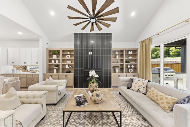 1015 Olympic Dr, Rockwall, TX 75087 - living room with vaulted ceiling, a tiled fireplace, and recessed lighting