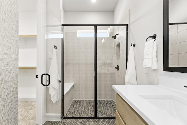 1015 Olympic Dr, Rockwall, TX 75087 - full bathroom featuring a shower stall, vanity, and a walk in closet