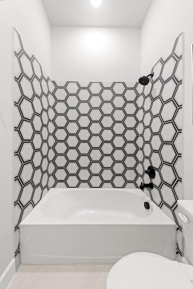 1015 Olympic Dr, Rockwall, TX 75087 - bathroom with toilet, bathtub / shower combination, and tile patterned flooring