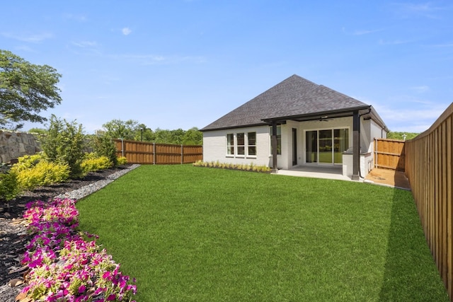 1015 Olympic Dr, Rockwall, TX 75087 - rear view of property featuring ceiling fan, roof with shingles, and a patio