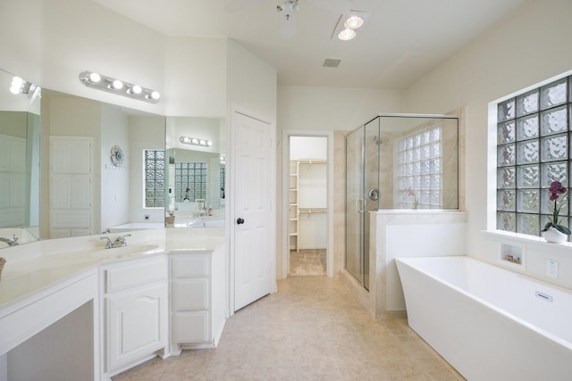 21 Graham Ln, Lucas, TX 75002 - full bathroom with a shower stall, a tub to relax in, vanity, a spacious closet, and tile patterned flooring