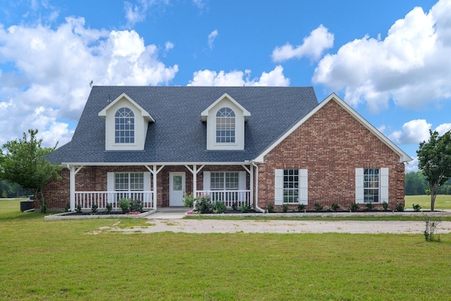21 Graham Ln, Lucas, TX 75002 - view of front of home featuring covered porch, brick siding, a front yard, and roof with shingles