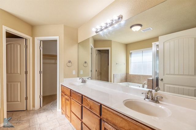 210 Miss Ellie Ln, Abilene, TX 79602 - bathroom with double vanity, a garden tub, and tile patterned flooring