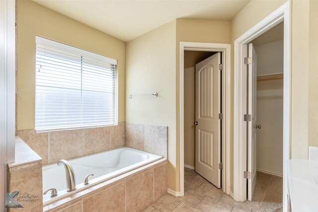 210 Miss Ellie Ln, Abilene, TX 79602 - bathroom featuring a garden tub and tile patterned flooring