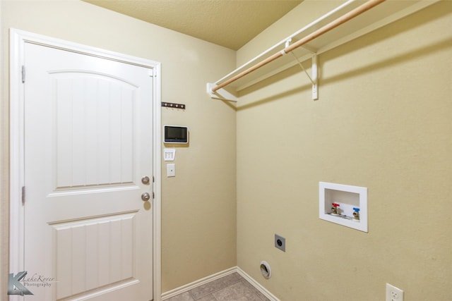 210 Miss Ellie Ln, Abilene, TX 79602 - laundry room with electric dryer hookup, hookup for a washing machine, light tile patterned flooring, and baseboards